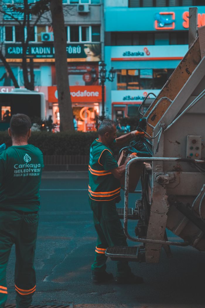 gallery-1 Sanitation crew managing waste disposal on city street during the day.